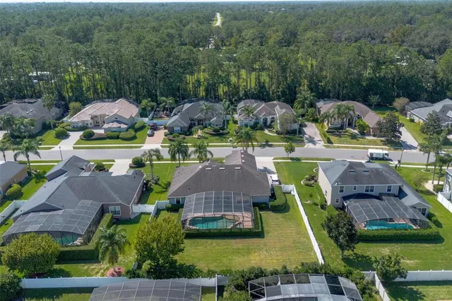 a front view of a house with a garden and trees