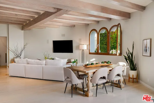 a large white kitchen with a large window