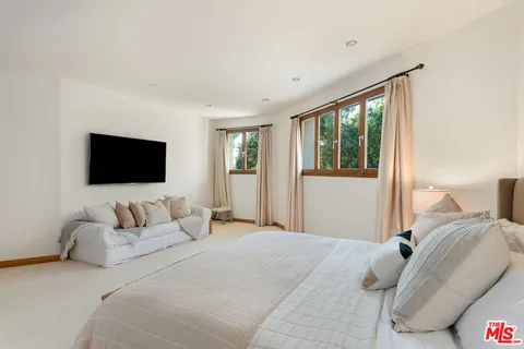 a view of a livingroom with furniture and a flat screen tv