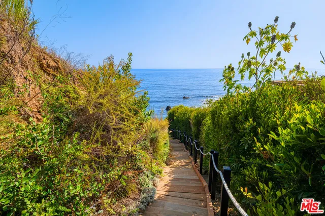 a living room with furniture a fireplace and a chandelier