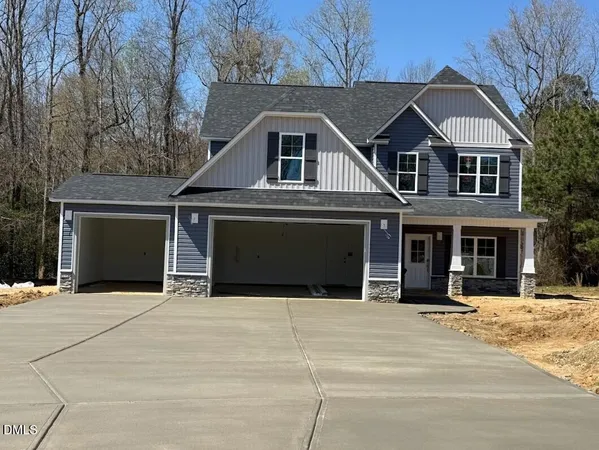a front view of a house with yard and garage