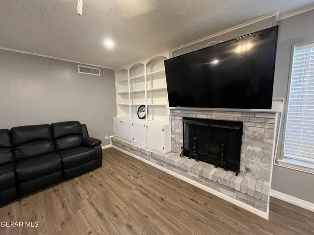 a kitchen with stainless steel appliances granite countertop a sink dishwasher a stove a dining table and chairs with wooden floor