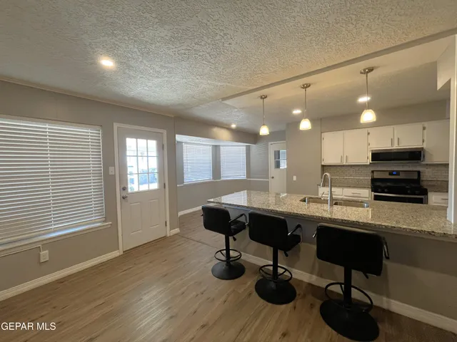 a kitchen with a table and chairs in it