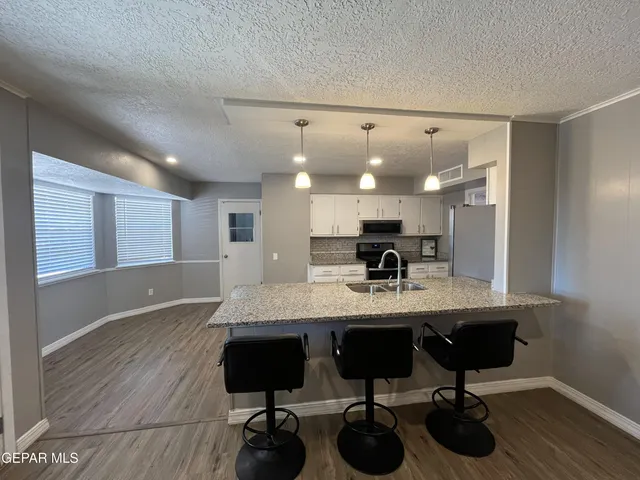 a kitchen with a sink appliances and cabinets