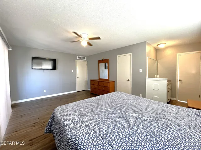 a bathroom with a sink a toilet a mirror and window