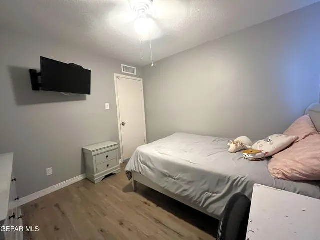 a bedroom with a bed and a desk