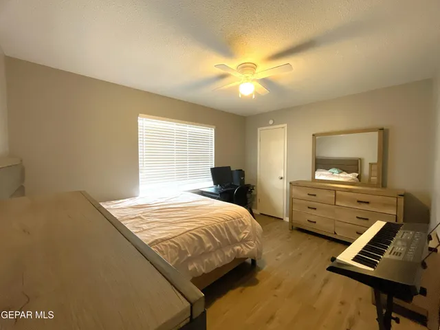 a living room with furniture a rug and white walls