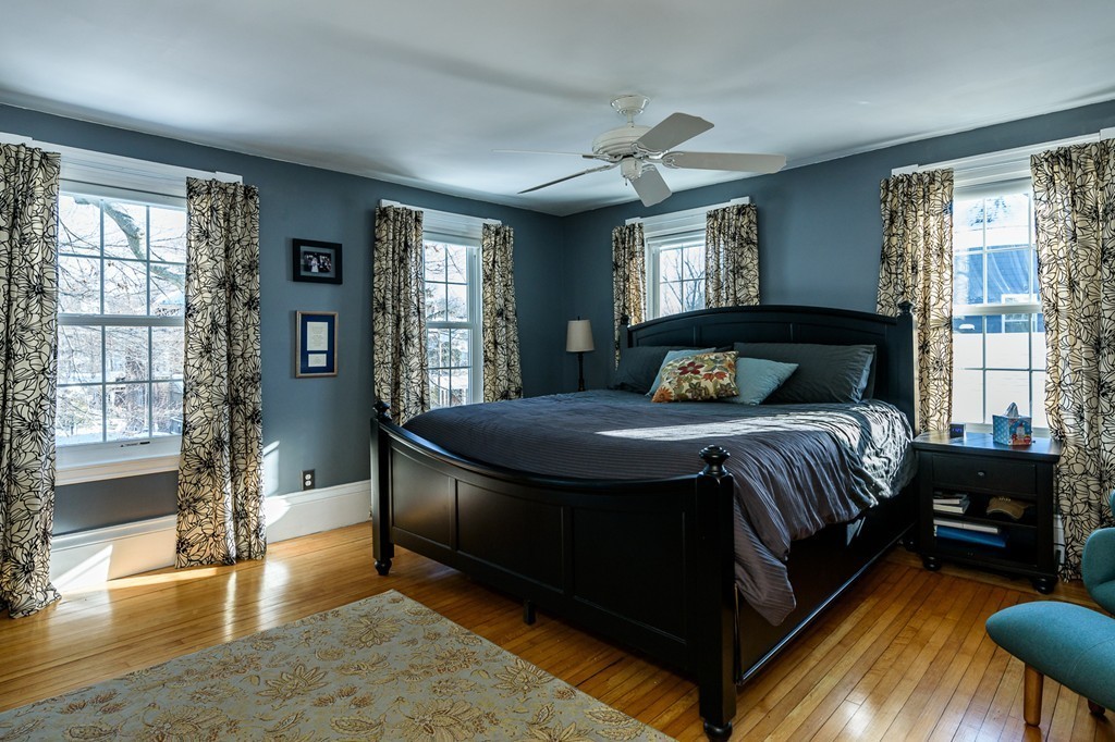 68 Maple Street Boston, MA 02132 - Photo 11 of 19 a bedroom with a bed and wooden floor