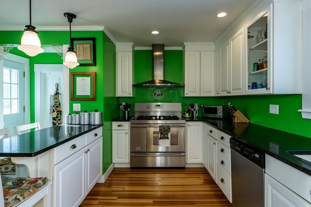 68 Maple Street Boston, MA 02132 - Photo 9 of 19 a kitchen with stainless steel appliances granite countertop a stove a sink and a refrigerator