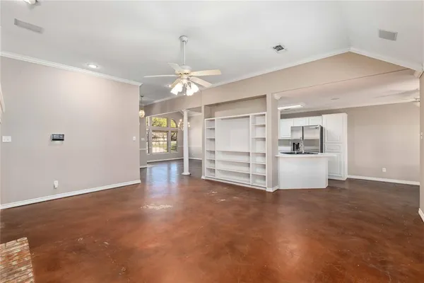 a view of an empty room with a kitchen