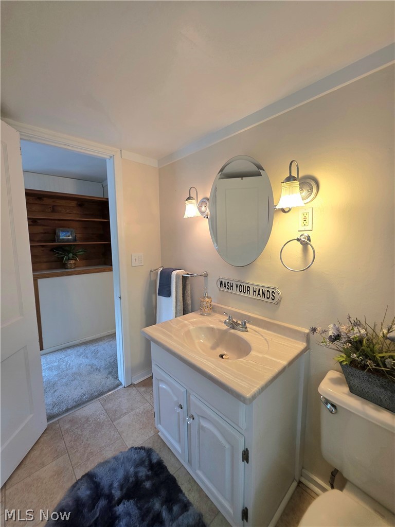 398 North Chillicothe Road Aurora, OH 44202 - Photo 19 of 39 Bathroom vanity with integrated sink and chrome faucet, set against a tiled floor