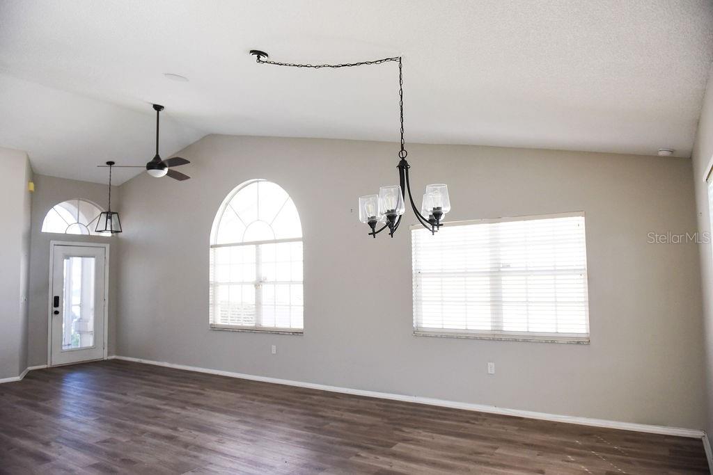 4819 West Raintree Bradenton, FL 34203 - Photo 11 of 37 an empty room with wooden floor fan and windows