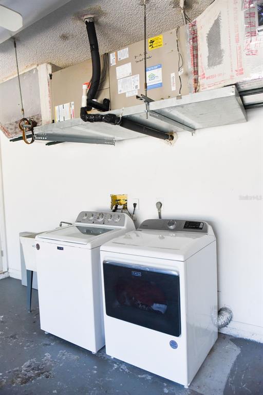 4819 West Raintree Bradenton, FL 34203 - Photo 16 of 37 a kitchen with a stove and a white cabinet