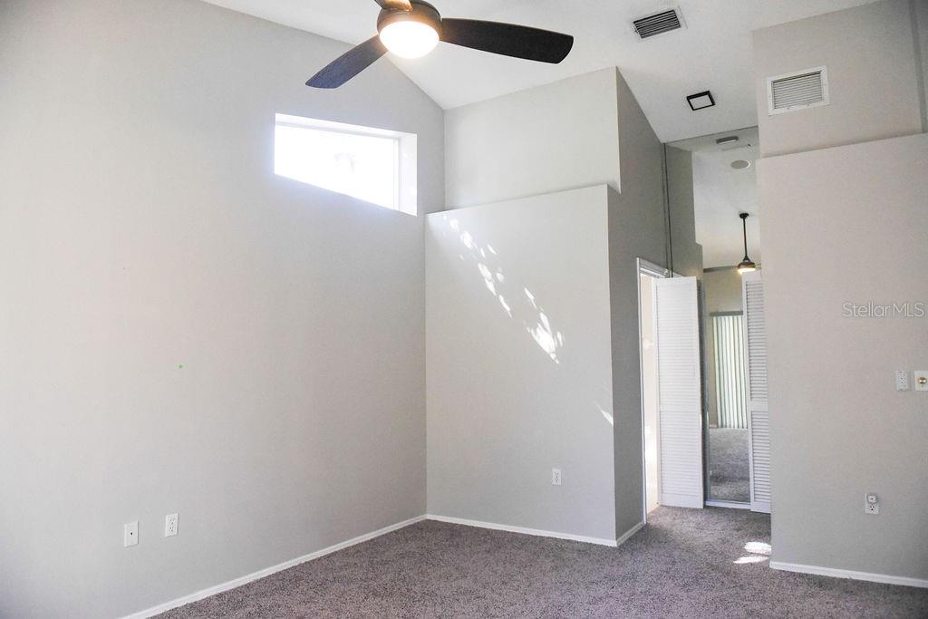 4819 West Raintree Bradenton, FL 34203 - Photo 18 of 37 an empty room with a ceiling fan and a window