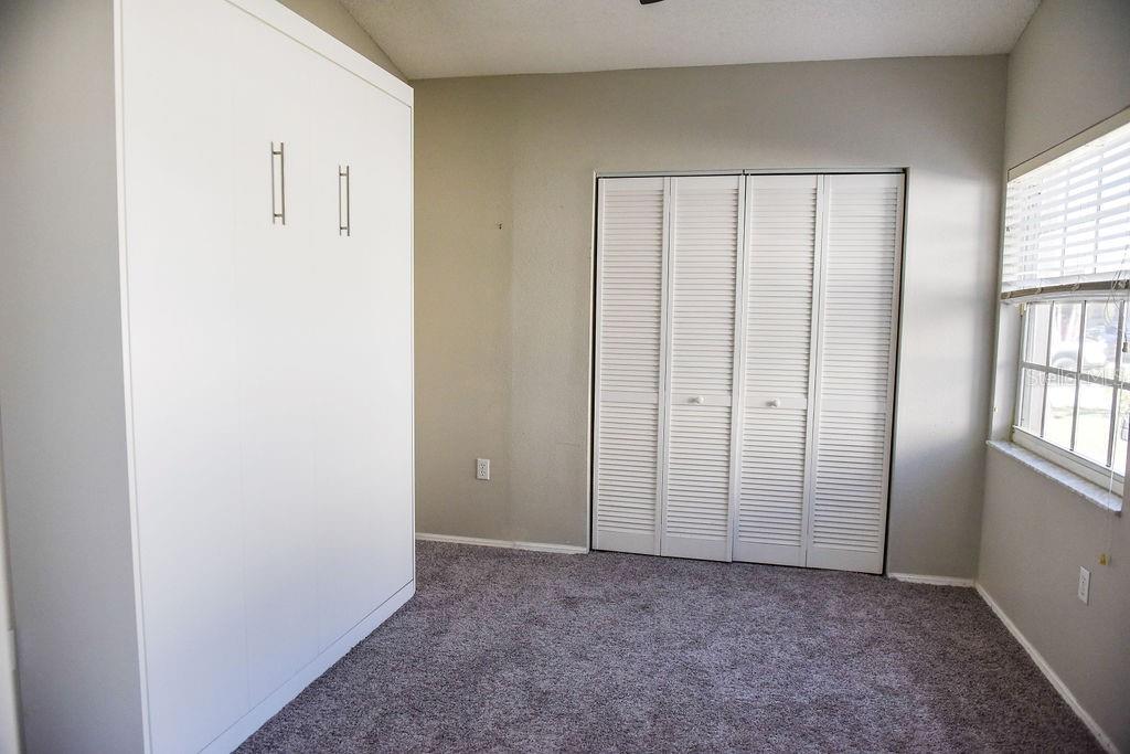 4819 West Raintree Bradenton, FL 34203 - Photo 22 of 37 an empty room with windows and closet