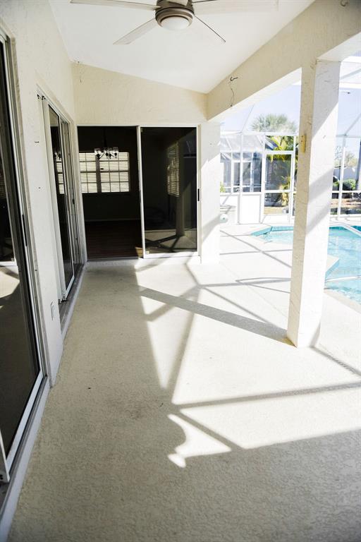 4819 West Raintree Bradenton, FL 34203 - Photo 27 of 37 a view of a hallway with a dining table and chair