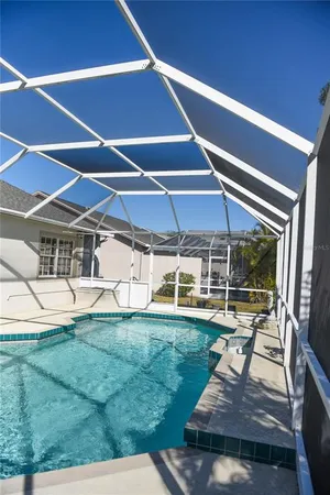 a view of a patio with a table and chairs under an umbrella