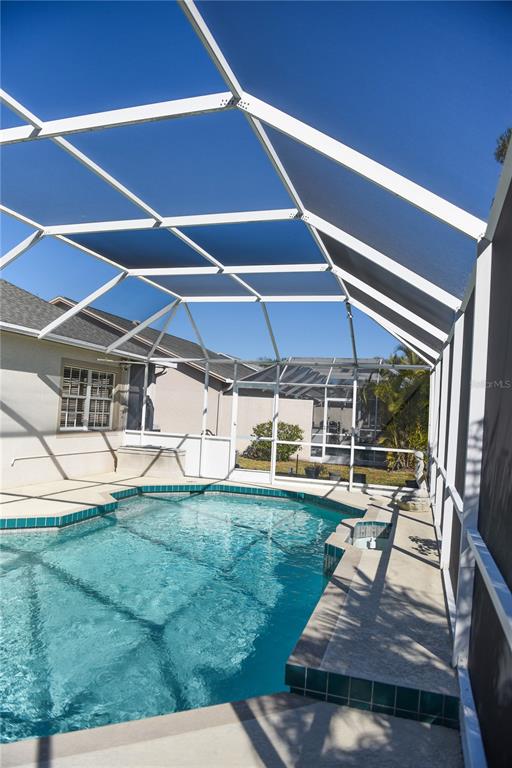 4819 West Raintree Bradenton, FL 34203 - Photo 31 of 37 a view of a patio with table and chairs a barbeque