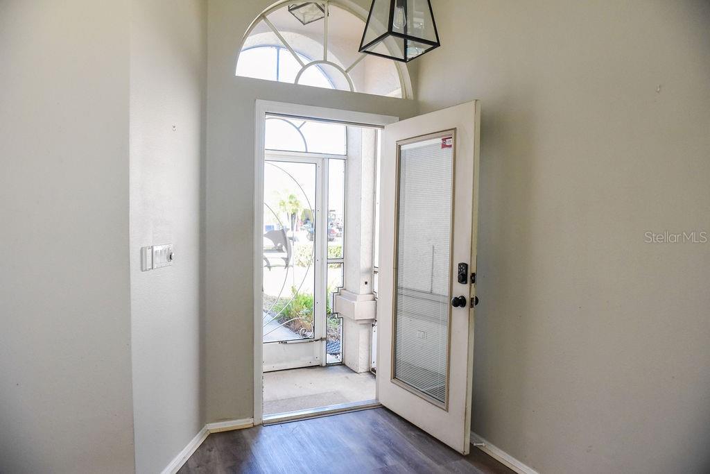 4819 West Raintree Bradenton, FL 34203 - Photo 6 of 37 a view of an entryway with wooden floor