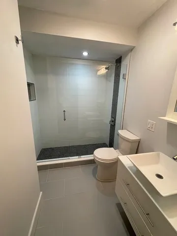 a bathroom with a toilet sink and shower