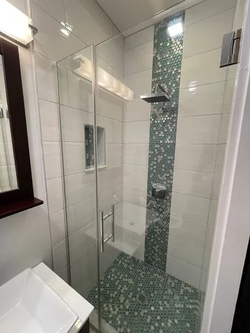 a bathroom with a shower and a sink