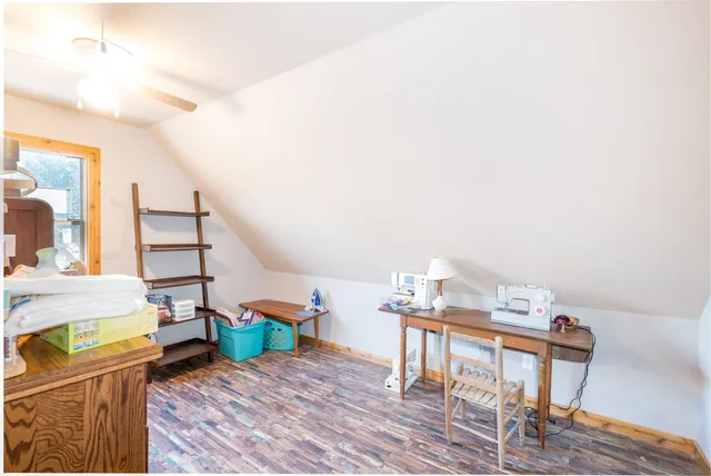 a room with wooden floor and a window