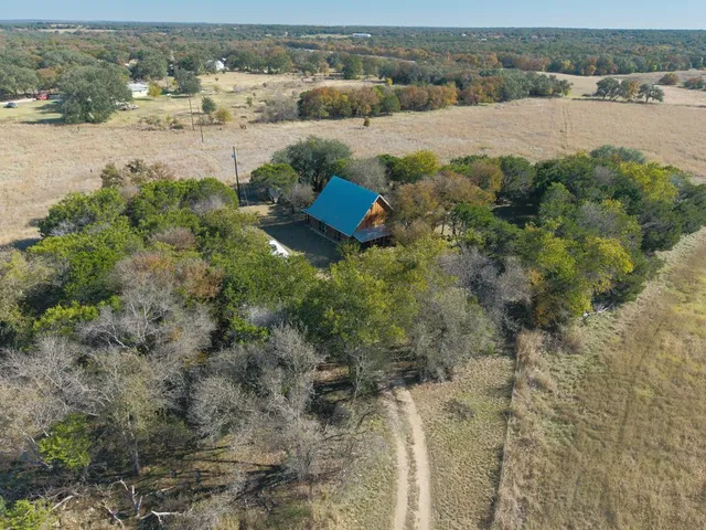 an aerial view of a house with a yard