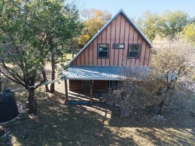 a view of a house with a yard and wooden deck