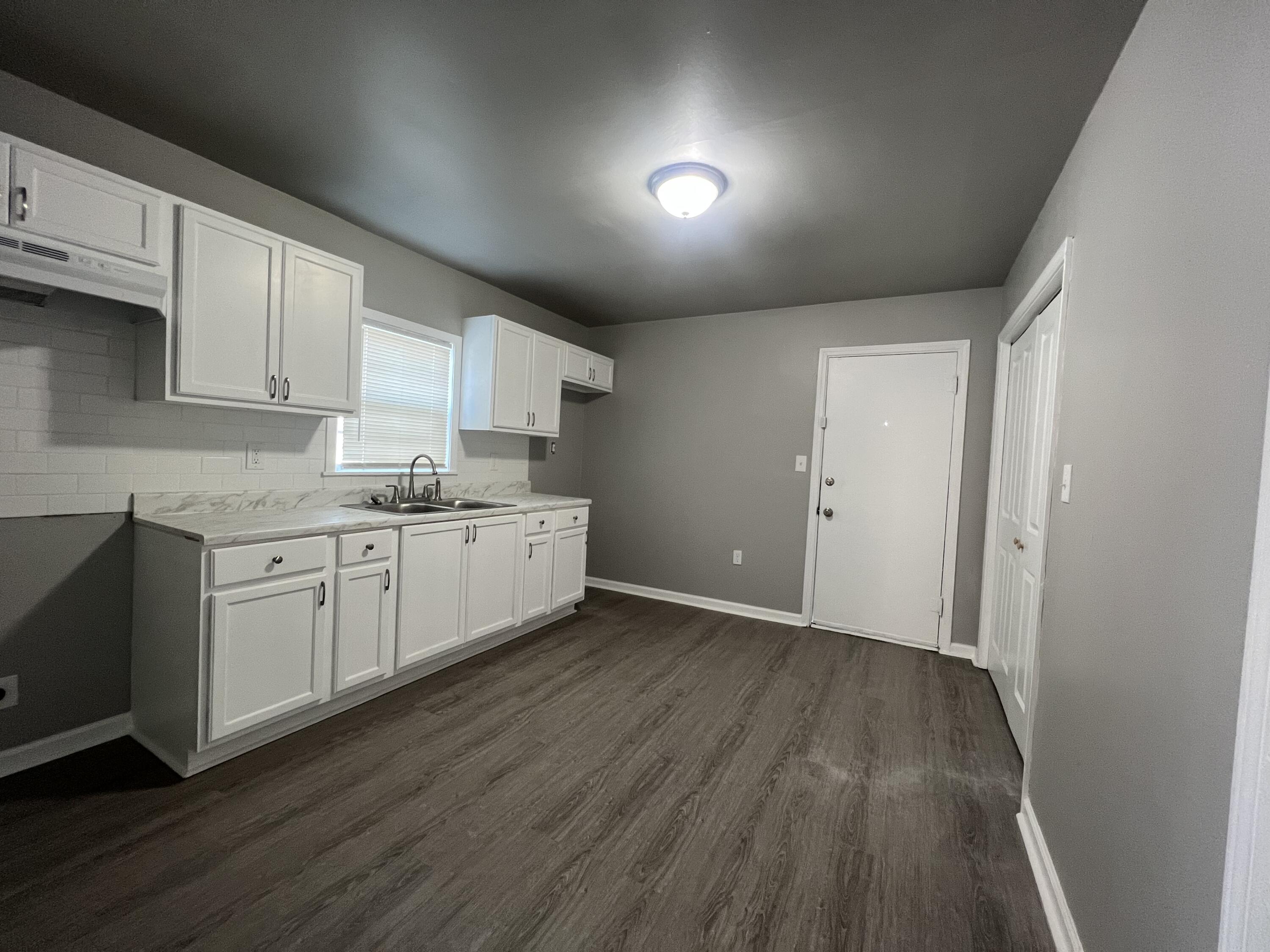 3403 31st Street Lubbock, TX 79410 - Photo 2 of 8 a view of a kitchen with wooden floor and electronic appliances