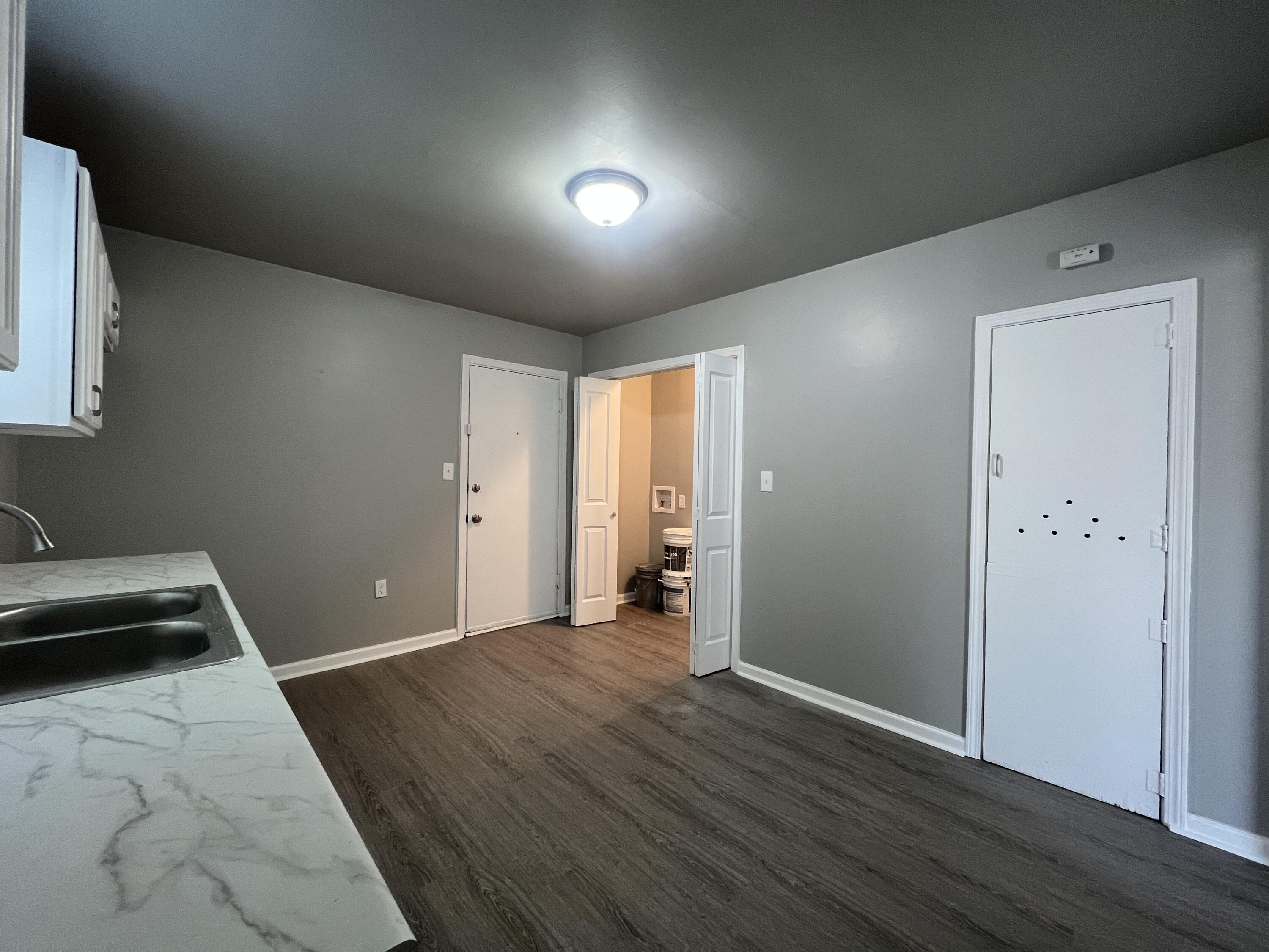 3403 31st Street Lubbock, TX 79410 - Photo 3 of 8 a view of a room with wooden floor and a sink