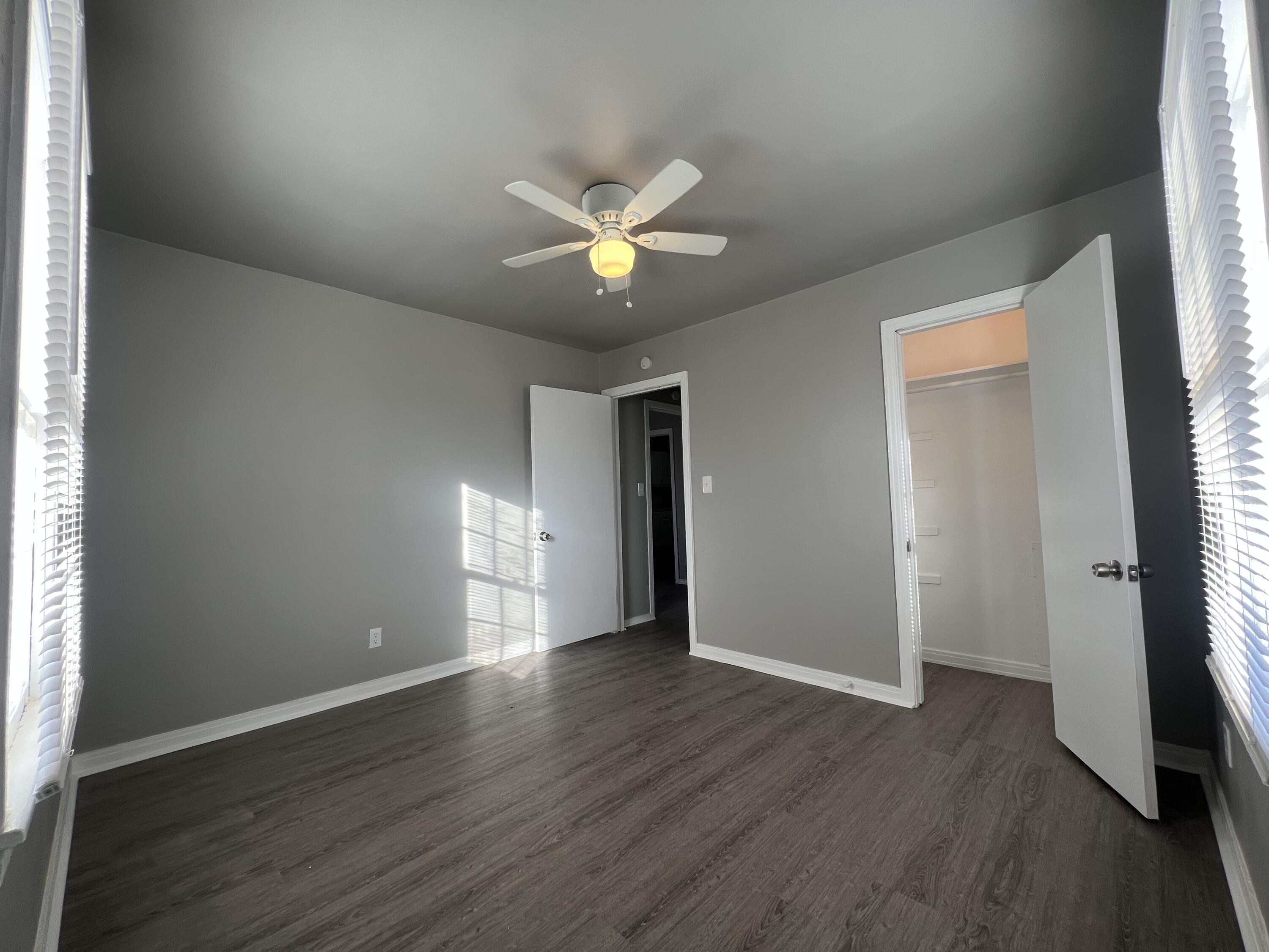3403 31st Street Lubbock, TX 79410 - Photo 4 of 8 an empty room with wooden floor and a ceiling fan