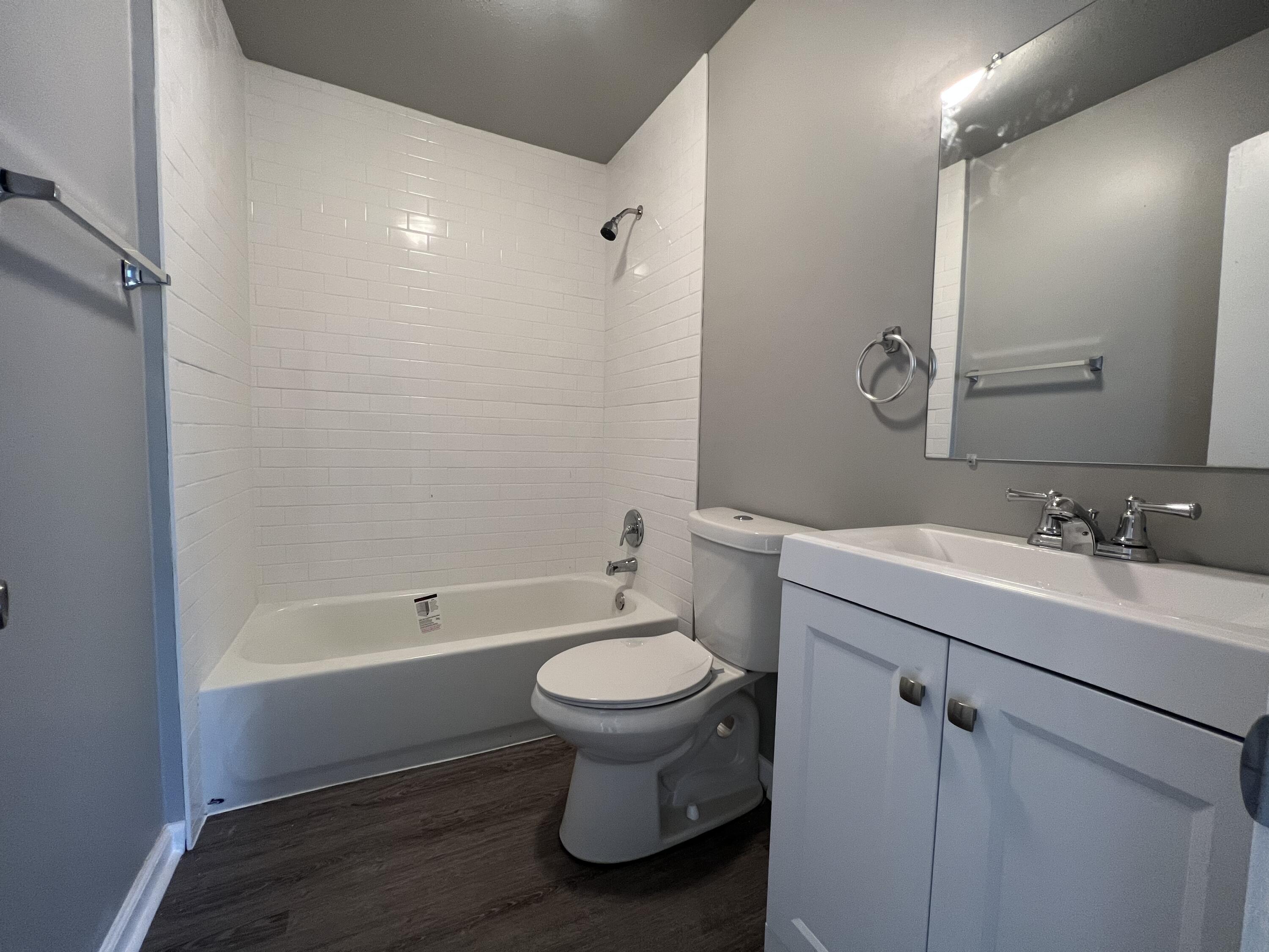 3403 31st Street Lubbock, TX 79410 - Photo 5 of 8 a bathroom with a sink toilet and a bathtub