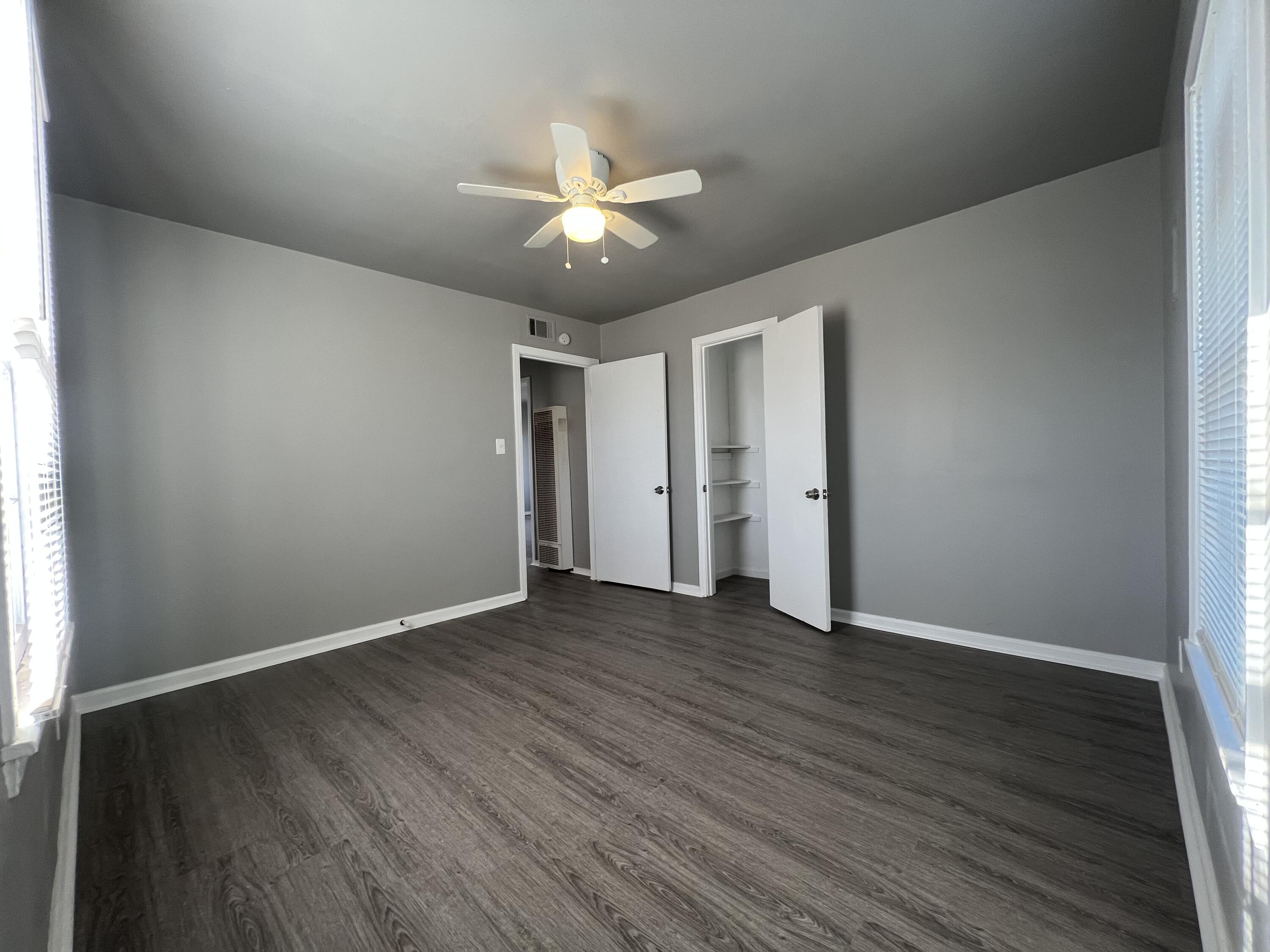 3403 31st Street Lubbock, TX 79410 - Photo 6 of 8 an empty room with wooden floor and windows