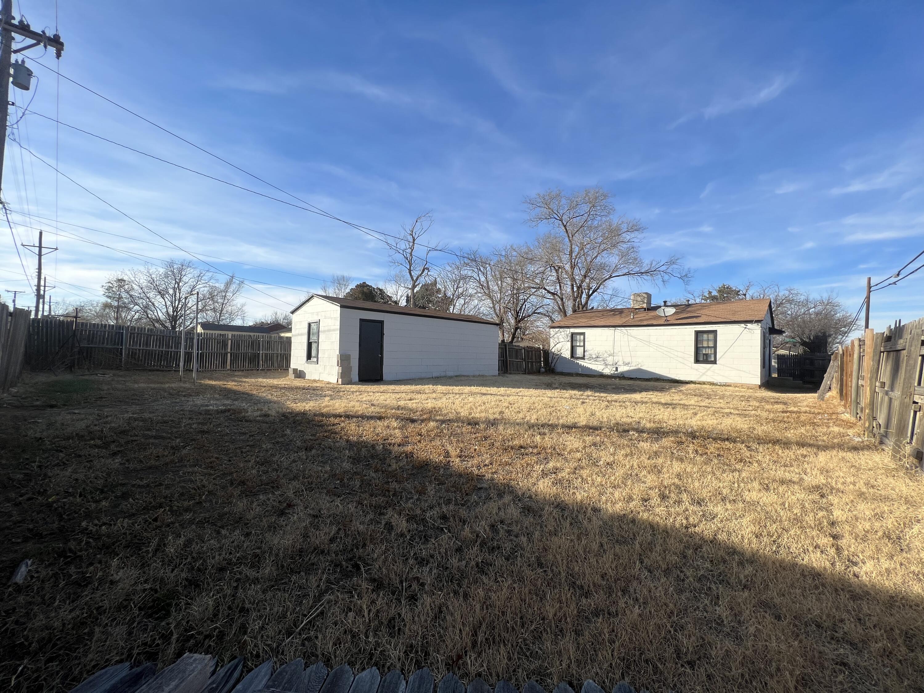 3403 31st Street Lubbock, TX 79410 - Photo 7 of 8 a front view of a house with a yard