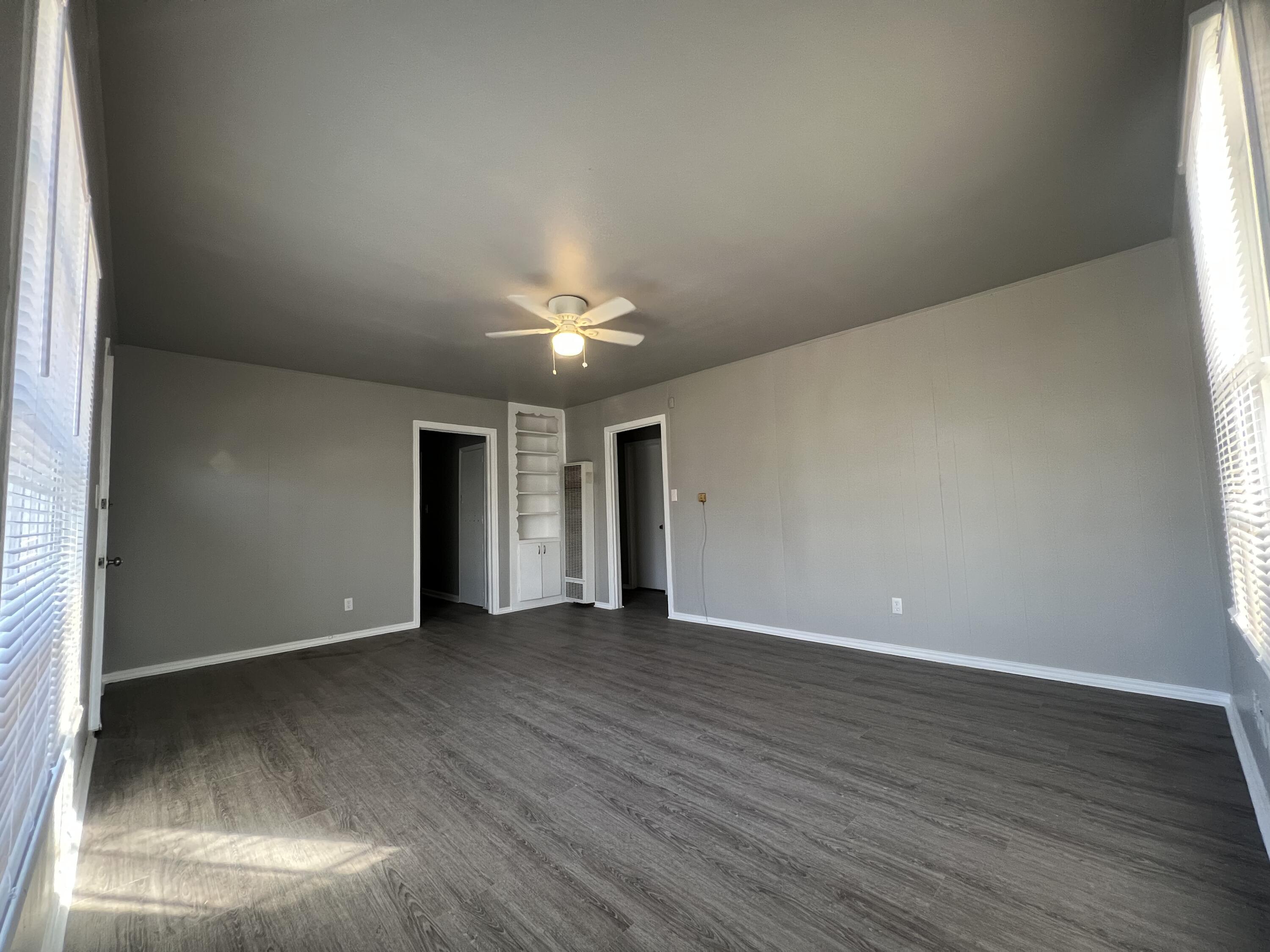 3403 31st Street Lubbock, TX 79410 - Photo 8 of 8 an empty room with wooden floor and windows
