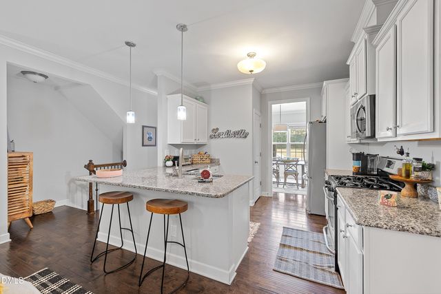 a kitchen with stainless steel appliances a sink stove and refrigerator