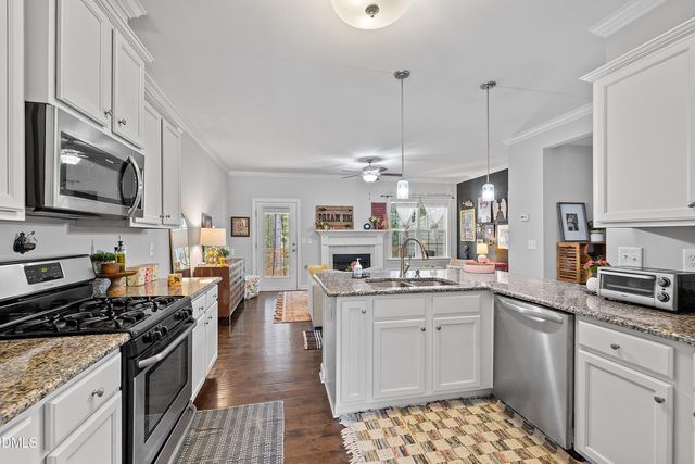 a kitchen with refrigerator a stove a microwave and cabinets