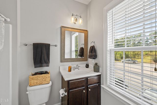 a bathroom with a shower curtain and a sink