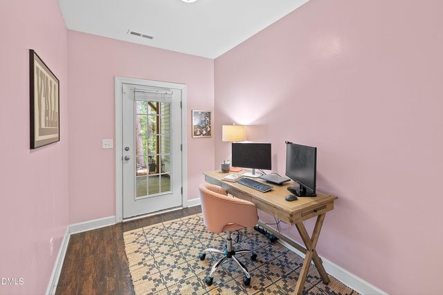 a view of a workspace with furniture and wooden floor