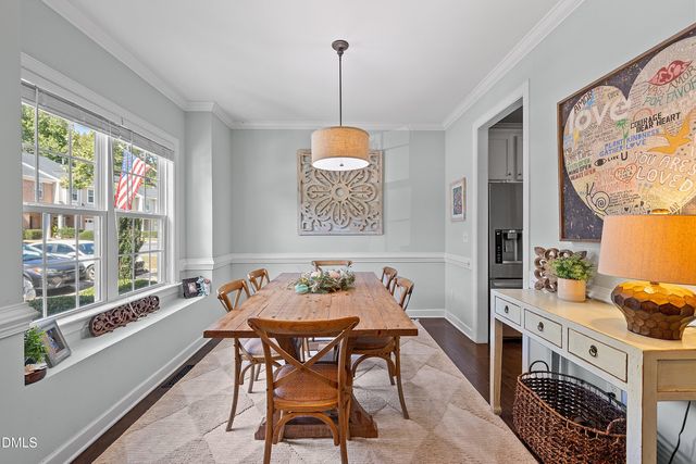 a dining room with furniture a chandelier and window