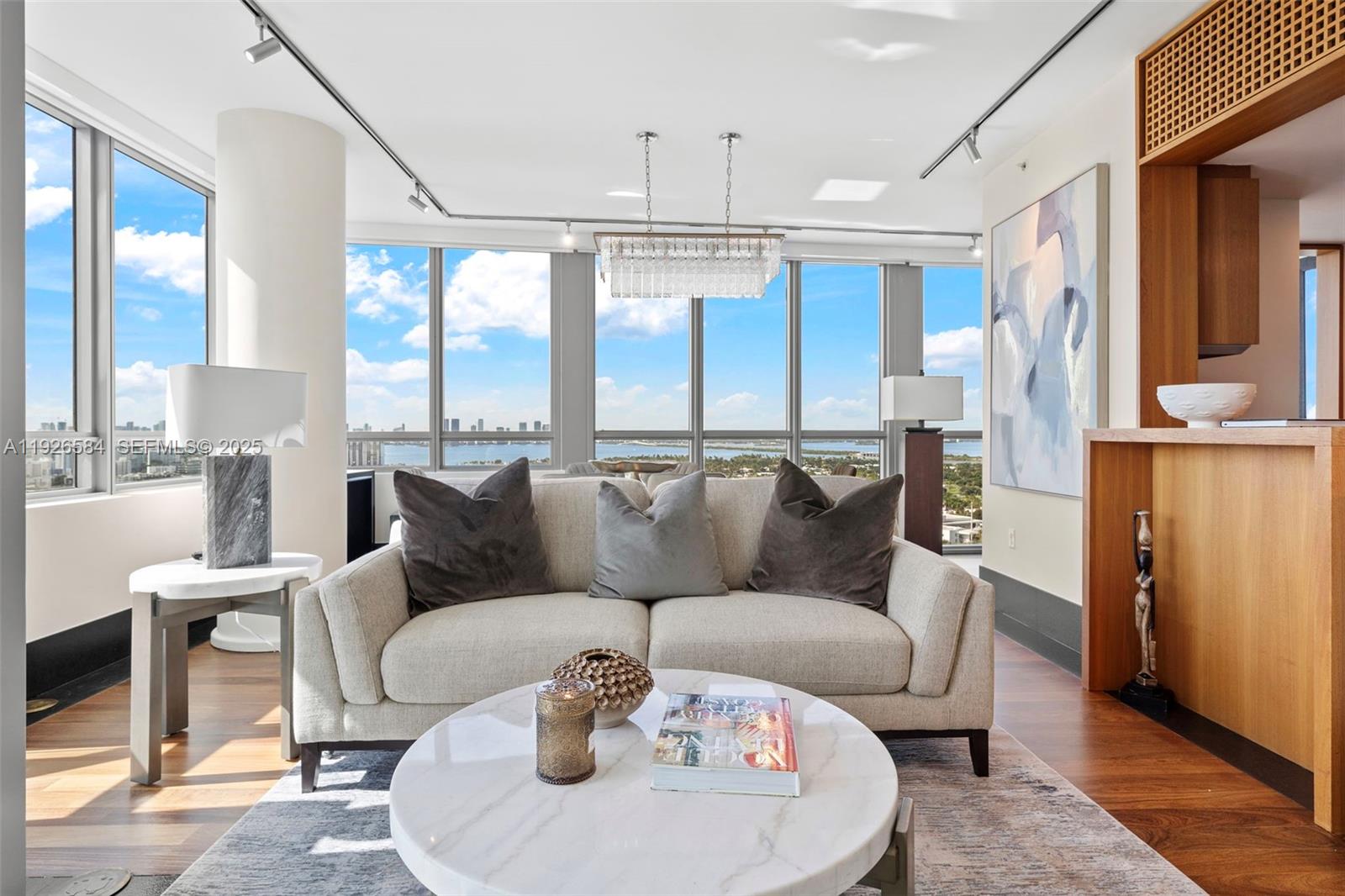 101 20th Street, Unit 3202 Miami Beach, FL 33139 - Photo 13 of 54 a living room with furniture and a chandelier