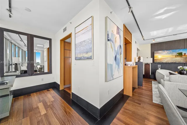 a dining room with furniture and large windows