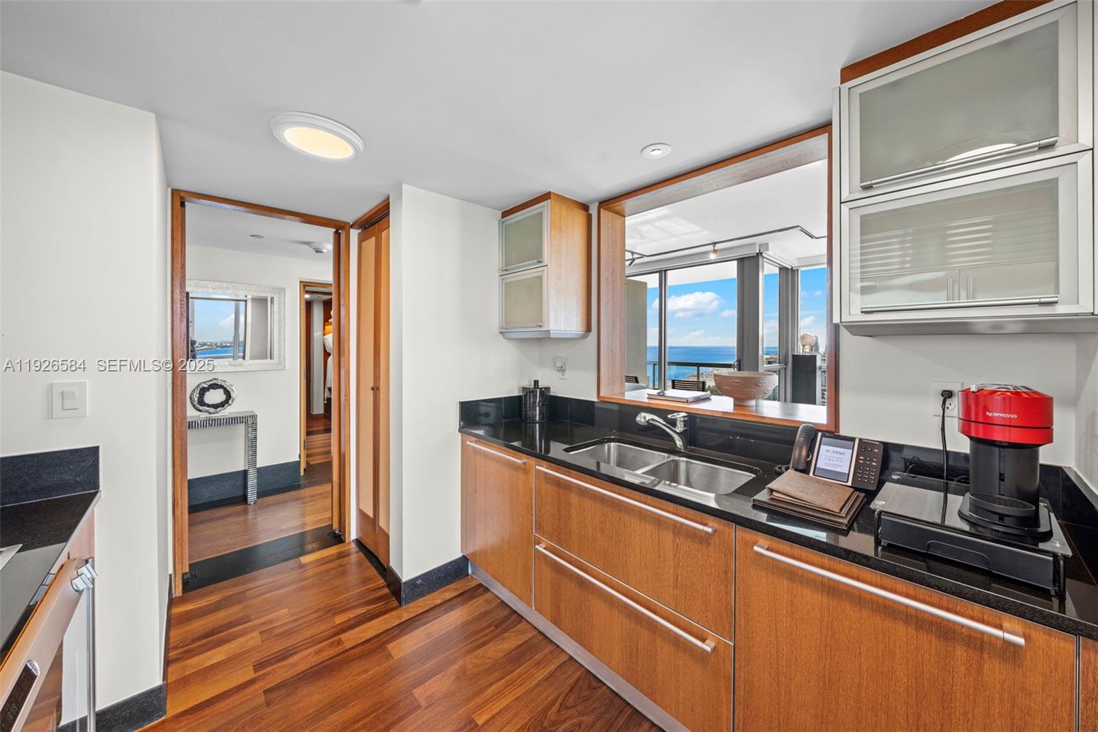 101 20th Street, Unit 3202 Miami Beach, FL 33139 - Photo 22 of 54 a kitchen with granite countertop a sink cabinets and stainless steel appliances