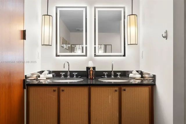 a bathroom with a sink a toilet and mirror