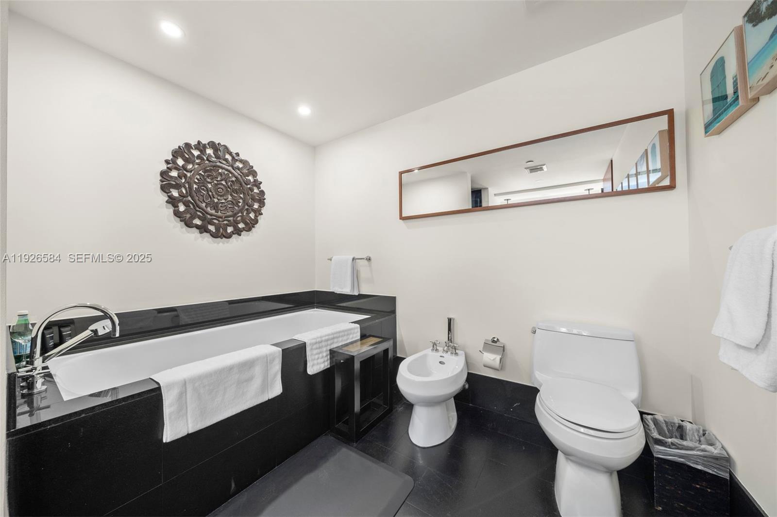 101 20th Street, Unit 3202 Miami Beach, FL 33139 - Photo 36 of 54 a bathroom with a sink a toilet and mirror