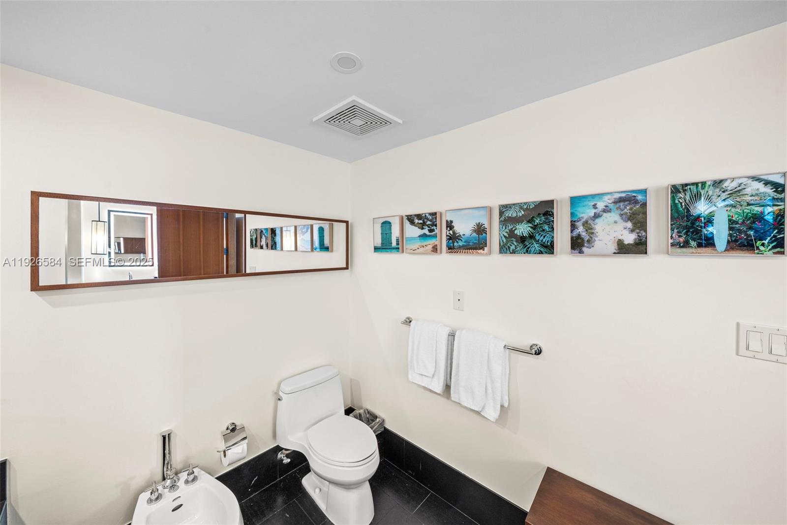 101 20th Street, Unit 3202 Miami Beach, FL 33139 - Photo 37 of 54 a bathroom with a toilet sink and mirror