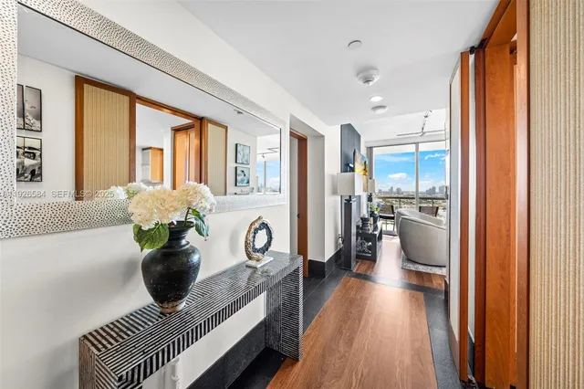 a living room with stainless steel appliances furniture and a table