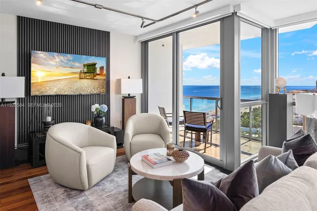 a living room with furniture and a potted plant