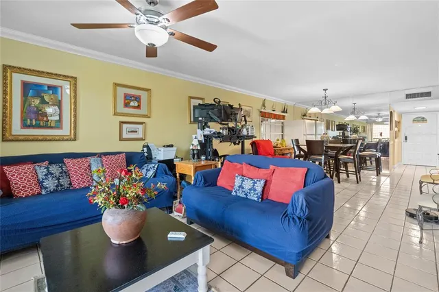 a living room with furniture and kitchen view