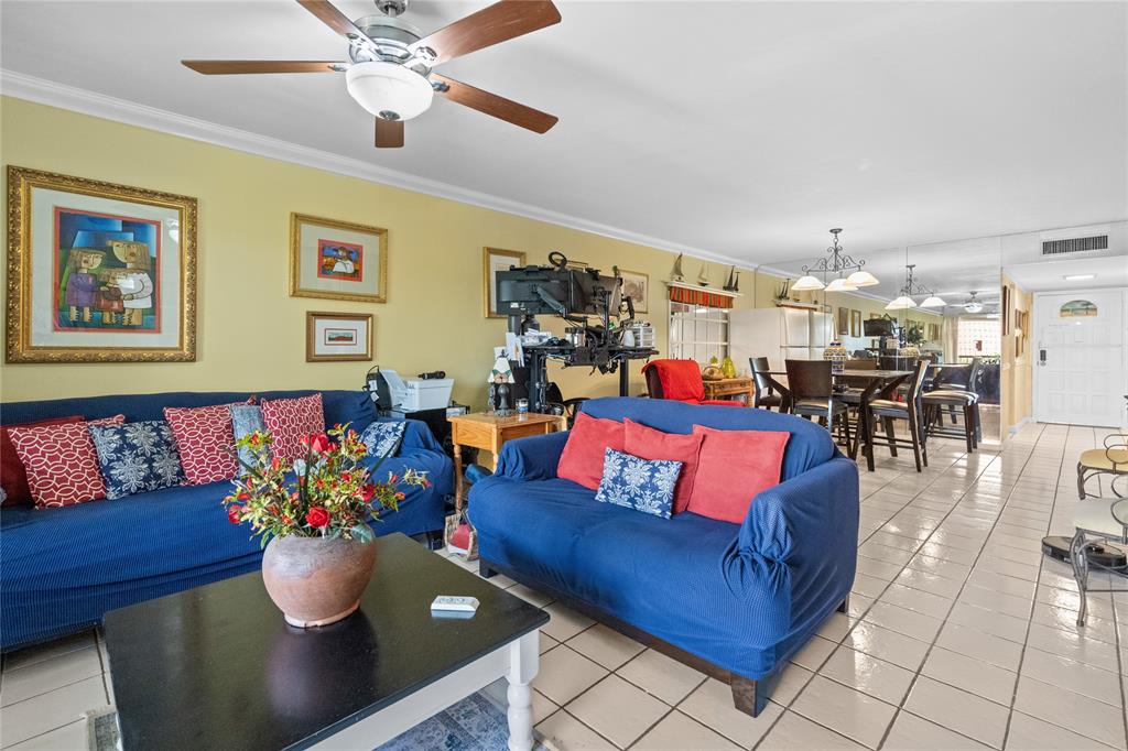 a living room with furniture and kitchen view